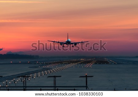 Similar – Image, Stock Photo An airplane on approach. It is reflected on a window front at the airport building.