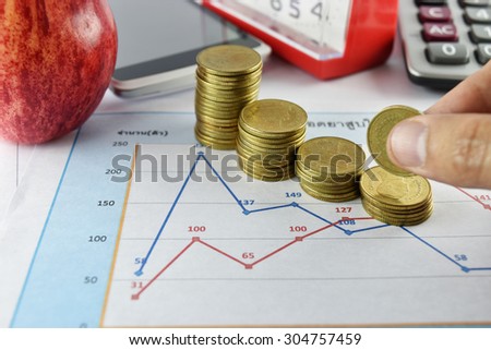 Hand, pen, apple, money,clock, telephone and calculator placed on document., concept for business