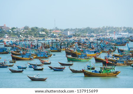 MUI NE, VIETNAM - FEBRUARY 24: A lot of local fishing boats have a day rest till the night, February 24, 2013 in Mui Ne, Vietnam. Mui Ne is a very popular tourist attraction in Vietnam.