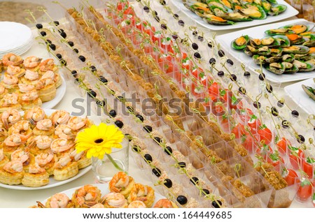 a lot of cold snacks and drinks on buffet table, catering
