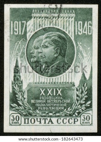 SOVIET UNION - CIRCA 1946: A stamp printed by the Soviet Union Post is a entitled 29 years to the Russian revolution. It shows portraits of Lenin and Stalin, circa 1946