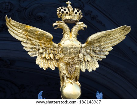 ST. PETERSBURG - JUNE 30, 2011: One of three golden double headed eagles at forged gate at Southern facade of the Winter Palace. From 1732 to 1917 it was the official residence of Russian monarchs.