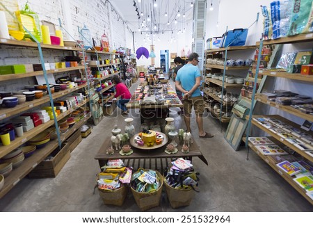 HO CHI MINH, VIETNAM - JAN 15, 2015: Unidentified Caucasian people watch goods at a souvenir shop in the downtown.