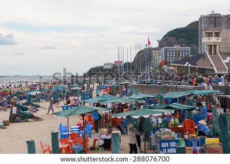 VUNG TAU, VIETNAM - JUNE 10, 2015: A lot of people have a rest at the sea beach. Vung Tau is a sea city in the south of the country.