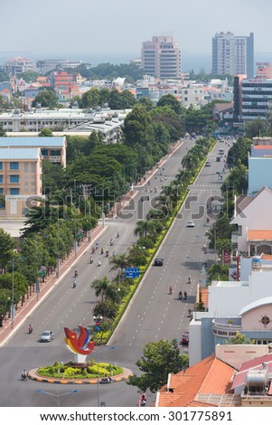 VUNG TAU, VIETNAM - JUNE 29, 2015: Motorcyclists and vehicles move along a road in the downtown. Vung Tau is a maritime city in the southern Vietnam.
