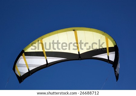 kite boarding yellow kite in deep blue sky