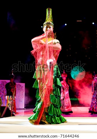ULAN-UDE, RUSSIA - OCTOBER 29: A model demonstrates a dress in ethnic style at the international fashion festival of asian designers on October, 29, 2009, Ulan-Ude, Buryatia, Russia.