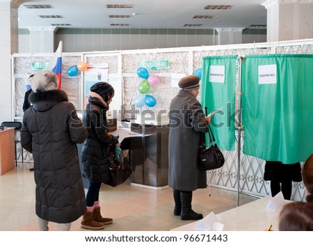 ULAN-UDE, RUSSIA - MARCH 4: Unidentified voters at the local polling station 699 stand in line to voting booths at the presidential election of Russian Federation on March 4, 2012 in Ulan-Ude, Buryatia, Russia.
