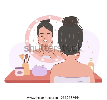 Girl doing skin care routine at a mirror. Beauty procedures at the dressing table.