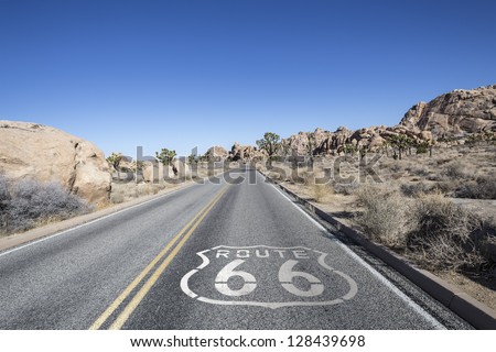 Joshua tree highway with Route 66 pavement sign in California\'s Mojave desert.