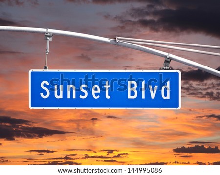 Sunset Blvd overhead street sign with sunset sky.