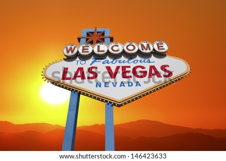 Las Vegas welcome sign with blazing desert sunset.