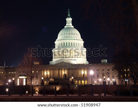 Historic US Capitol building at night in Washington DC.