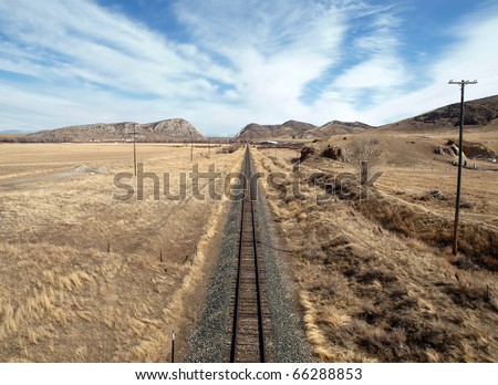 Simple rail through the open expanse of the midwestern United States.