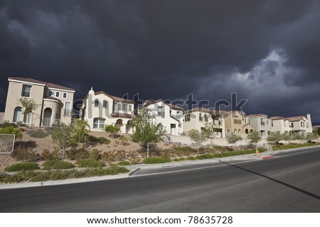 Thunderstorm approaches a brand new row of suburban homes in a southern Nevada desert community.