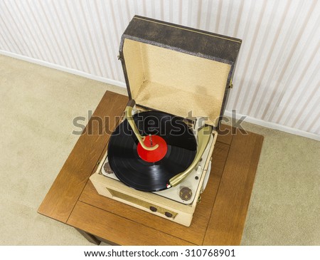 Old record player with vintage vinyl disk.
