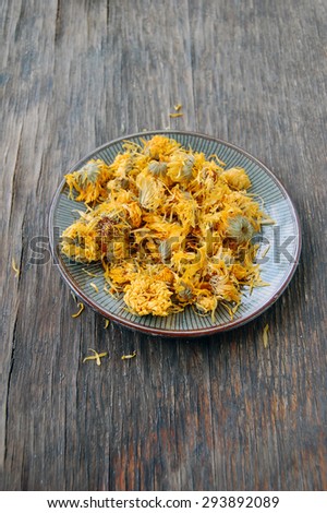dried marigold on wooden table