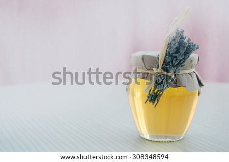 harmonic background with lavender honey in jar and lavender flowers