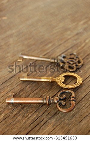 old vintage keys on rustic wooden table