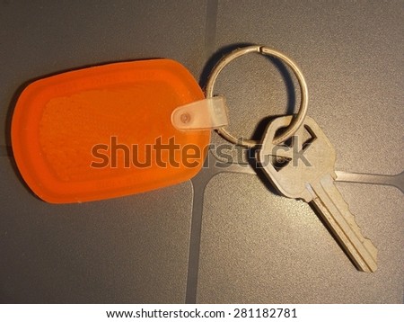 Bright Orange Key Fob with House Key - Isolated Close Up Photograph with Copy Space