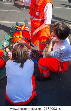 MILAN, ITALY - MAY, 18: Emergency personnel render aid to a girl during an emergency simulation on May 18, 2014
