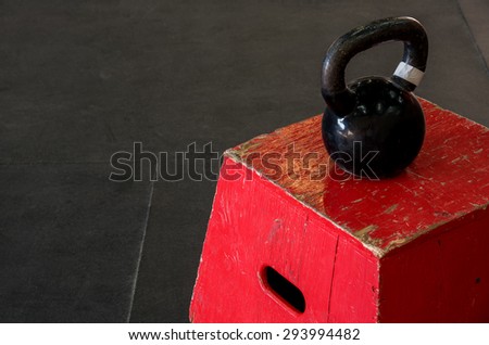 Red jump box with a black kettle bell, close-up