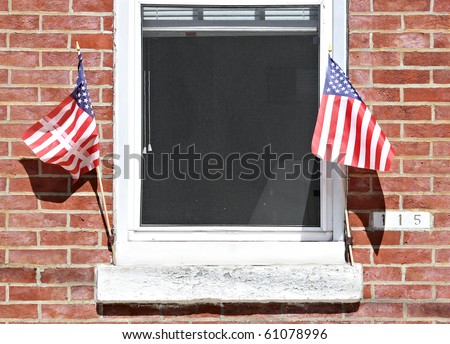 Window on a brick wall with American flags