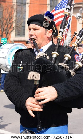 SCRANTON, PA - MARCH 14: A man plays the bagpipes in the Scranton St. Patrick\'s Day parade on March 14, 2009. Scranton holds one of the largest parades in the United States.