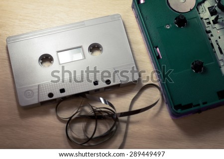 old Cassette Tape player and recorder with audio cassette on old wood background