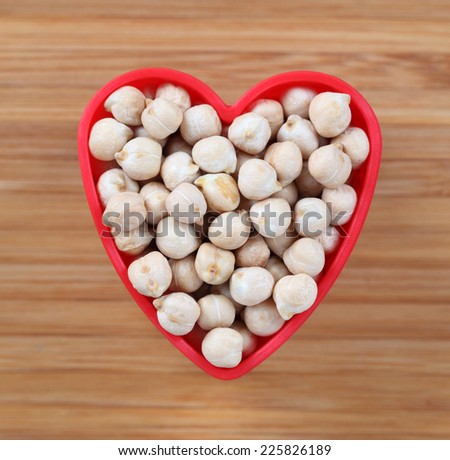 Chickpeas in a heart bowl. Close-up.