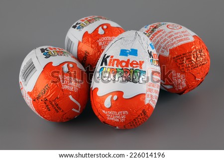 Tambov, Russian Federation - April 04, 2013: Four Kinder Surprise Eggs on grey background. Each Kinder Surprise egg consists of a chocolate shell, a plastic capsule with toy, and external foil wrap.