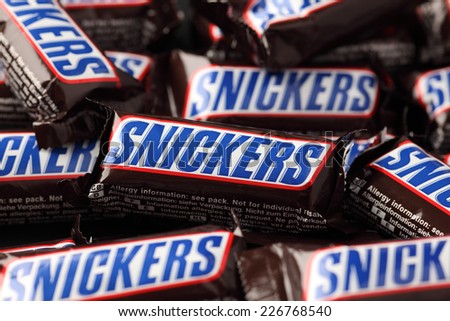 Tambov, Russian Federation - September 01, 2012: Snickers minis candy bars heap. Full Frame. Snickers bar is a chocolate bar with caramel and peanuts, manufactured by Mars, Incorporated.