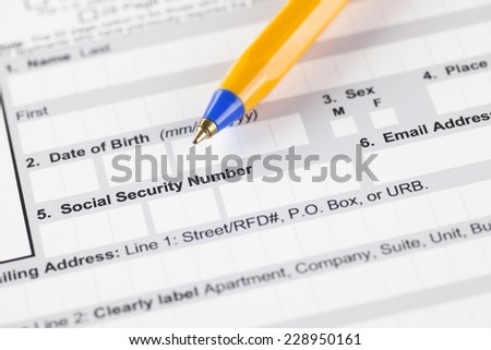 Application form with ballpoint pen. Focus on social security number\'s fields.