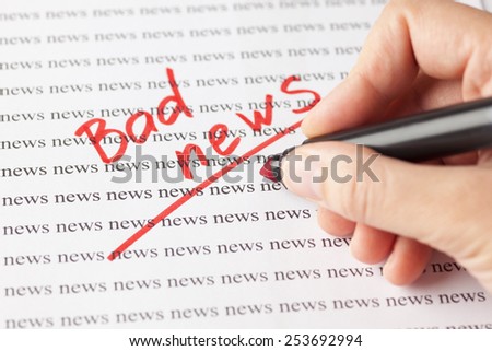 Woman\'s hand with red pen writing word \