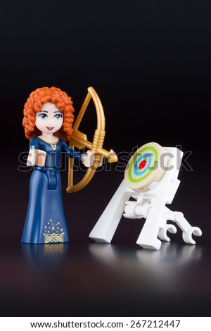 Tambov, Russian Federation -April 30, 2014 Merida minifigure with bow and target from LEGO brand Disney Princess on black background. Studio shot.
