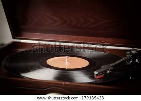 Vintage record player with vinyl record selective focus