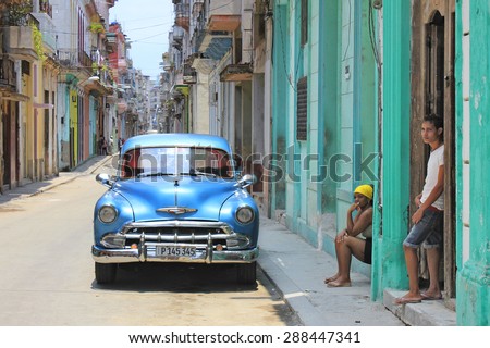 HAVANA, CUBA - MAY 30, 2015: old car and people resting in the streets.