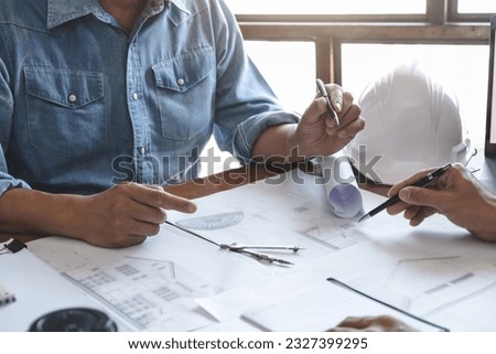 Similar – Image, Stock Photo Architects working material in the foreground, in the background a blurred employee in front of the monitor