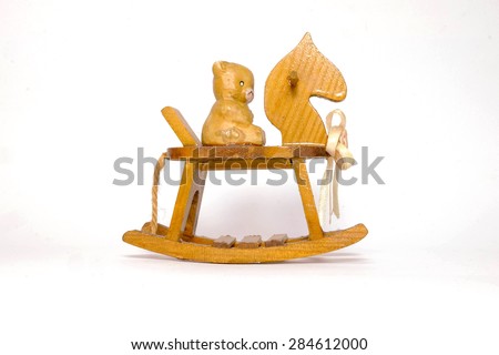 Bear sitting on a rocking horse