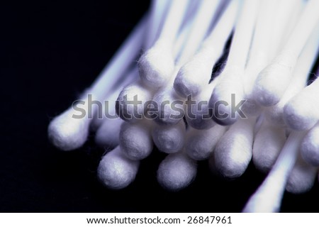 Close up of cotton buds against black background