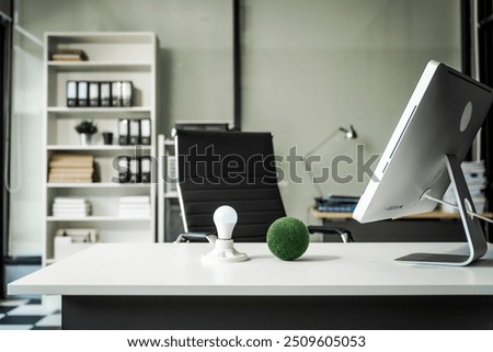 A modern office desk with a laptop, monitor, and plant. sleek, minimal design features open space, technology and productivity. room is empty, offering a clean and organized workspace.