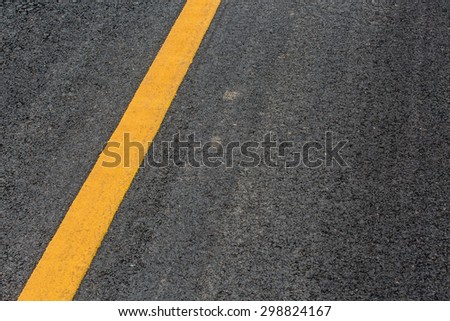Yellow line on asphalt street road texture background