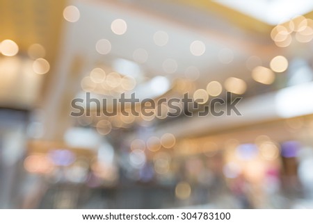Blurred bokeh abstract background in shopping mall in holiday sunny day