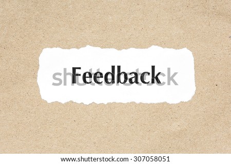 Feedback word on white ripped paper on brown document texture