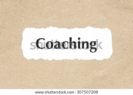Coaching word on white ripped paper on brown document texture