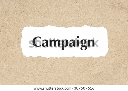 Campaign word on white ripped paper on brown document texture