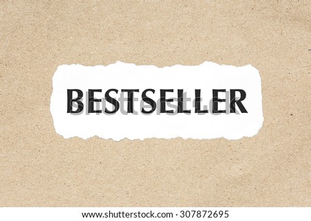 BESTSELLER word on white ripped paper on brown document texture