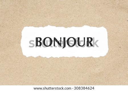 BONJOUR word on white ripped paper on brown document texture