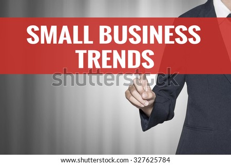 Small Business Trends word on virtual screen push by business woman red tab