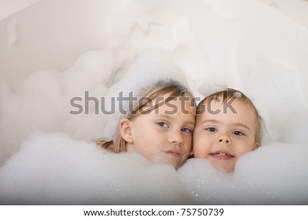 Brother and sister taking a bubble bath